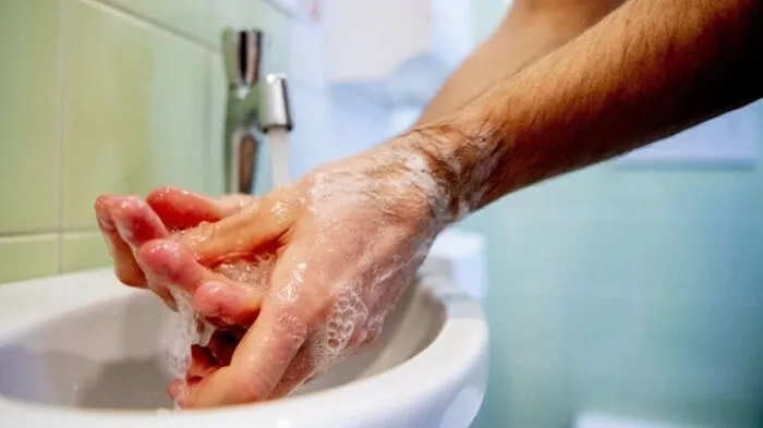 A care center employee washes his hands following hygiene guidelines as the institution readies preventive measures against a possible spread of the COVID-19, the novel coronavirus, which has already affected neighbouring countries, on February 27, 2020, in Horst aan de Maas. (Photo by Robin UTRECHT / ANP / AFP) / Netherlands OUT