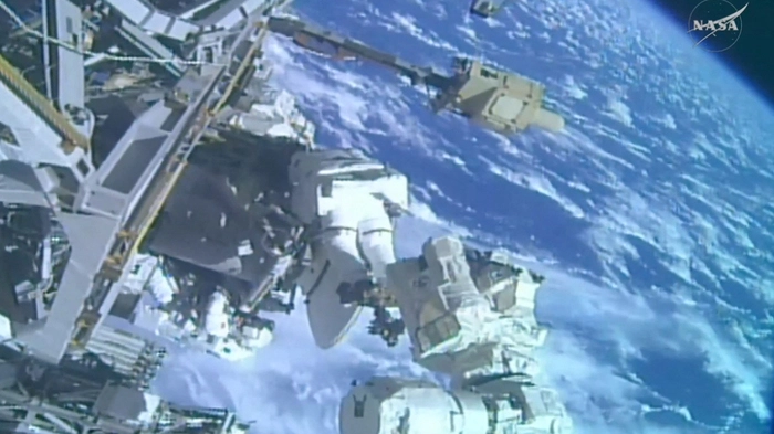 This August 25, 2026, frame grab from a NASA live video stream shows NASA astronaut Anil Menon (C) and ESA astronaut Sophie Adenot (lower L) working during their spacewalk outside the International Space Station (ISS). A week after her first historic spacewalk, French astronaut begn Sophie Adenot begain her second spacewalk on Tuesday, August 25. The pair of astronauts will finish installing a high-speed communications antenna on the International Space Station. (Photo by Handout / NASA / AFP) / RESTRICTED TO EDITORIAL USE - MANDATORY CREDIT "AFP PHOTO / NASA / HANDOUT" - HANDOUT - NO MARKETING NO ADVERTISING CAMPAIGNS - DISTRIBUTED AS A SERVICE TO CLIENTS