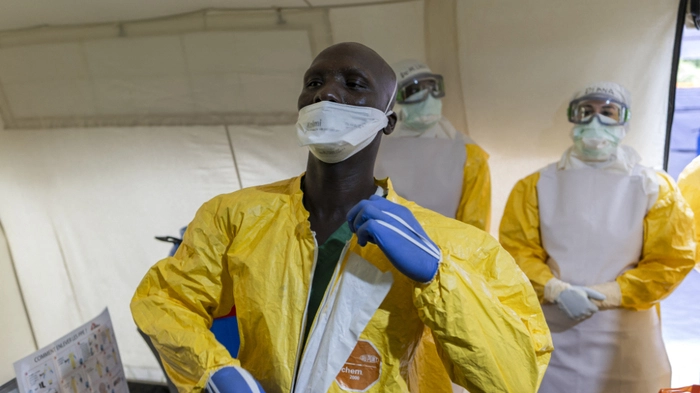 Health workers practice safe removal and disposal of used Personal Protective Equipment (PPE) at the 'Doffing' tent during a training by medical charity, Médecins Sans Frontières (MSF) to reinforce regional emergency response capacity for Ebola in the Democratic Republic of Congo (DRC) at Ongata Rongai, Kajiado County in Kenya on July 10, 2026. The Ebola simulation treatment centre was set up by the medical charity Médecins Sans Frontières (MSF) a few weeks after the Ebola outbreak was officially declared on May 15 in the Democratic Republic of Congo (DRC). According to the African Union's health agency, Africa CDC, the outbreak is spreading faster than any previous one and has already killed at least 600 people. (Photo by Tony KARUMBA / AFP)