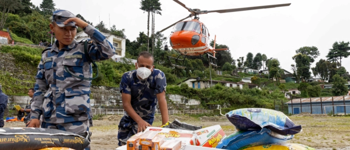 Nepal Armed Police Force (APF) personnel load relief supplies for flood victims onto a helicopter at Dhunche Bazaar in Nepal's Rasuwa district on August 31, 2026. At least 4,471 people were listed as missing on August 31, with a further 955 confirmed dead, after the flash floods and landslides that hit the Nepal border. (Photo by PRABIN RANABHAT / AFP)