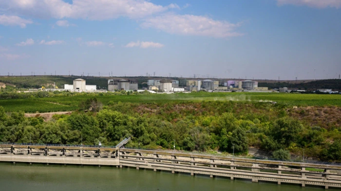 A general view of Cernavoda Nuclear Power Plant (CNE Cernavoda) in Cernavoda city, next to Danube-Black Sea channel September 3, 2025. The Nuclear Power Plant in Cernavod? is the only nuclear power plant in Romania. It produces around 20% of the country's electricity. The nuclear plant uses CANDU (Canada deuterium uranium) reactor technology from AECL (Atomic Energy of Canada Limited). The initial plan was to build four units, and schedule their startup from 1985 onward. A fifth unit was subsequently planned on the direct orders of Communist leader Nicolae Ceausescu. Units 1 and 2 are currently operational. Three more partially completed CANDU reactors exist on the same site, numbered Unit 3 to Unit 5. (Photo by Daniel MIHAILESCU / AFP)