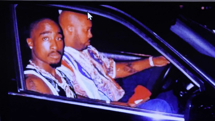 A photograph of rapper Tupac Shakur and Suge Knight, taken by Leonard Jefferson just minutes before the fatal shooting is displayed during the murder trial of Duane Davis, related to the 1996 killing of Shakur, at Clark County District Court at the Regional Justice Center in Las Vegas, Nevada, on August 21, 2026. The trial of the former gang leader accused of orchestrating the murder of rapper Tupac Shakur began on August 10, 30 years after one of America's most high-profile unresolved killings. The proceedings, expected to last a month, will likely not make clear who fired the shots that killed the California hip-hop legend on the night of September 7, 1996, while he was in Las Vegas to see a Mike Tyson boxing match. (Photo by Bizuayeha TESFAYE / POOL / AFP)