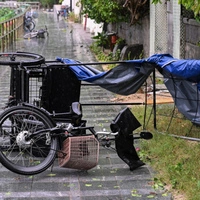 A trike is seen overturned on a beach path by strong winds from Typhoon Noul which passed close to Hong Kong on July 26, 2026. (Photo by Peter PARKS / AFP)