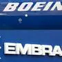 (FILES) This combination of file pictures created on December 21, 2017 shows the Boeing logo on the fuselage of a Boeing 787-10 Dreamliner at Le Bourget Airport on June 18, 2017, and the logo of Brazil's Embraer at Le Bourget Airport, on June 23, 2013. - Boeing announced on April 25, 2020, it was pulling out of a $4.2 billion deal to acquire the commercial plane division of its Brazilian rival Embraer. The companies had planned to form a joint venture in which Boeing would take an 80 percent stake in that division. The deal had been due to be finalized no later than April 24. (Photos by ERIC PIERMONT / AFP)