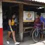 People are seen in a store where bitcoins are accepted in El Zonte, La Libertad, El Salvador on September 4, 2021. - The Congress of El Salvador approved in June a law that will make bitcoin legal tender in the country from September 7, with the aim of boosting its economy although analysts warn of a negative impact. (Photo by MARVIN RECINOS / AFP)