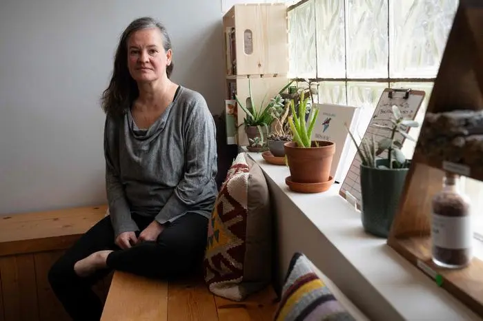 Jennifer Nikolaeff, 53, on administrative leave from USAID, poses at Bluebird Yoga in Washington, DC, March 14, 2025. As dramatic job losses mount among government staff, a sense of gloom has descended on the city. Of Washington's 700,000 residents, 70,000 are federal employees with at least another 110,000 living in the suburbs. Civil servants and contract workers, who are often passionate about politics and tend to be left-leaning, look on distraught as President Trump and his fellow Republicans slash the government and moves to shut many of its agencies headquartered in the city. (Photo by Daniel WOOLFOLK / AFP)