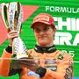 TOPSHOT - McLaren's Australian driver Oscar Piastri celebrates on the podium with his trophy after winning the Formula One Chinese Grand Prix at the Shanghai International Circuit in Shanghai on March 23, 2025. (Photo by JADE GAO / AFP)