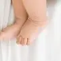 Bedtime. Adorable baby sleeping with his mother in bed, touching hands, top view, copy space