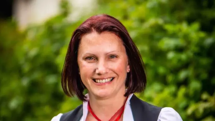 Eine Frau in Tracht lächelt in die Kamera