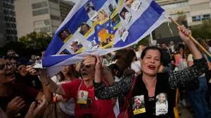 People react as they celebrate following the announcement that Israel and Hamas have agreed to the first phase of a peace plan to pause the fighting, at a plaza known as Hostages Square in Tel Aviv, Israel, Thursday, Oct. 9, 2025. (AP Photo/Ohad Zwigenberg)
