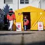 Medical workers walk in front of one of the entrances of the Community Health Centre in Kranj, Slovenia, on March 23, 2020 amid concerns over the spread of the COVID-19 coronavirus. (Photo by Jure Makovec / AFP)