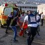 Israeli security forces and medics transport casualties along with local residents, at a site where a reported strike from Lebanon fell in Majdal Shams village in the Israeli-annexed Golan area on July 27, 2024. (Photo by Jalaa MAREY / AFP)