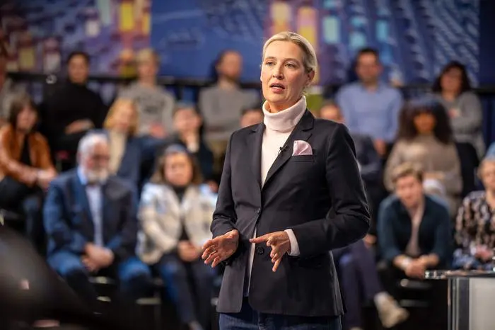 Co-leader of the far-right Alternative for Germany (AfD) party Alice Weidel gestures as she talks with citizens during the TV Programm 'Klartext' hosted by the public broadcaster ZDF in Berlin on February 13, 2025. (Photo by Michael Kappeler / POOL / AFP)