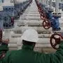 Engineer of the E.ON Natural Gas Storage Company checks the pressure in the pipeline pumping natural gas out of the underground storages near the Ukrainian border in Hajduszoboszlo (230 km/140 miles east of Budapest), Hungary, Wednesday, Jan. 7. 2009. Wednesday Hungary started to use its gas reserve from storage facilities while authorities restricted natural gas supply to industrial clients including Budapest Airport as Russia's gas shipments to Europe via Ukraine stopped after the two countries continued to dispute pricing, transit fees and outstanding debt. (AP Photo/Bela Szandelszky)