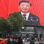 People watch an outdoor screen showing the live speech of Chinese President Xi Jinping during the opening session of the 20th Chinese Communist Party Congress in Hangzhou, in Chinas eastern Zhejiang province on October 16, 2022. (Photo by AFP) / China OUT