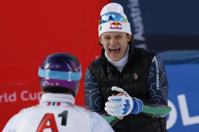 Brazil's Lucas Pinheiro Braathen congratulates Norway's Atle Lie McGrath, back to camera, at the finish area of an alpine ski, men's World Cup giant slalom, in Soelden, Austria, Sunday, Oct. 27, 2024. (AP Photo/Alessandro Trovati)