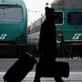 A passenger walks past trains at Rome's central station, 30 November 2004 as millions of workers across Italy observe a general strike in protest against the economic policies of Prime Minister Silvio Berlusconi's centre-right government. Unions said that more than a million protesters took to the streets of the country's main cities in a series of mass demonstrations as public service workers went on strike for eight hours and other sectors opted for a four-hour stoppage. Tens of thousands of travellers caught up in the strike had to cope with chaos at airports and rail stations around the country as trains and planes were cancelled. AFP PHOTO/ANDREAS SOLARO (Photo by ANDREAS SOLARO / AFP)