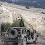 Israeli army humvees move in the UN-patrolled buffer zone separating Israeli and Syrian forces on the Golan Heights, near the Druze village of Majdal Shams in the Israel-annexed Golan Heights on December 21, 2024. (Photo by Jalaa MAREY / AFP)