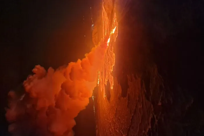 This handout picture released by the Icelandic Coast Guard on February 8, 2024 shows billowing smoke and flowing lava pouring out of a new fissure during a new volcanic eruption on the outskirts of the evacuated town of Grindavik, western Iceland. A volcanic eruption started on the Reykjanes peninsula in southwestern Iceland on Thursday, the third to hit the area since December, authorities said. (Photo by HANDOUT / Icelandic Coast Guard / AFP) / RESTRICTED TO EDITORIAL USE - MANDATORY CREDIT "AFP PHOTO /HANDOUT/ICELANDIC COAST GUARD " - NO MARKETING - NO ADVERTISING CAMPAIGNS - DISTRIBUTED AS A SERVICE TO CLIENTS
