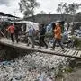 Children walk over a bridge in the Moria migrant camp on the Greek Aegean island of Lesbos on March 5, 2020. - Greece's defence ministry on March 5 announced a week-long shipping ban around Aegean islands facing a migration surge from Turkey, excepting only EU and NATO patrol vessels and registered commercial ships. Greece is attempting to hold back a migration surge by land and sea from neighbouring Turkey that began last week after Ankara said it would no longer stop asylum seekers from entering Europe. (Photo by LOUISA GOULIAMAKI / AFP)