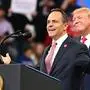 US President Donald Trump (R) smiles behind Kentucky Governor Matt Bevin during a rally at Rupp Arena in Lexington, Kentucky on November 4, 2019. (Photo by MANDEL NGAN / AFP)