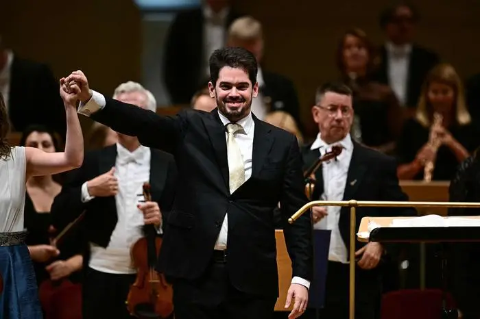 Israeli conductor Lahav Shani reacts as he receives applause during the Munich Philharmonic's concert performed during the Berlin Music Festival at the Konzerthaus concert hall in Berlin on September 15, 2025. The cancellation of a performance planned for September 18, 2025 at the Flanders Festival Ghent in Belgium by the Munich Philharmonic over concerns about its Israeli future chief conductor, Lahav Shani, has triggered a storm of criticism and accusations of antisemitism. (Photo by Tobias SCHWARZ / AFP)