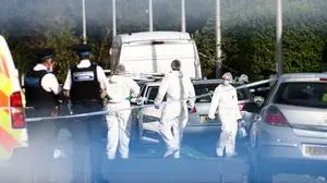 Police officers and forensic personnel stand behind a cordon on Hart Street in Southport, northwest England, on July 29, 2024, following a knife attack. Two children have been killed and nine more injured, six critically, in a knife attack in northern England, police said. A 17-year-old male has been arrested on suspicion of murder and attempted murder over the attack in Southport, near Liverpool in northwest England, which also left two adults with critical injuries, Merseyside Police said in a news conference. (Photo by Darren Staples / AFP)