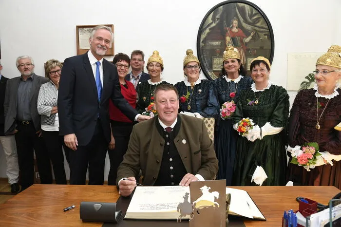 Oberbürgermeister Wolfgang Griesert aus Osnabrück (links stehend) und Bürgermeister Josef Jury beim Eintrag in das Goldene Buch der Stadt Gmünd.