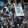 Le Havre's supporters wave flags and cheer for their team from the stands during the L1 French football match between Le Havre AC (HAC) and Stade Reims at the Oceane Stadium in Le Havre, north-western France, on November 10, 2024. (Photo by Lou BENOIST / AFP)