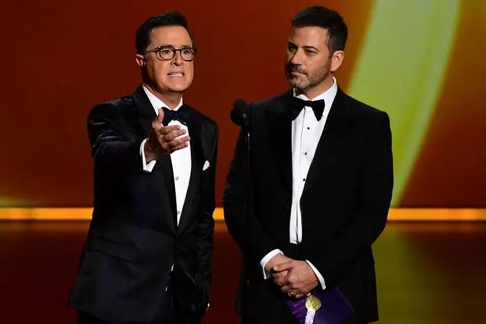 (FILES) Stephen Colbert (L) and Jimmy Kimmel speak onstage during the 71st Emmy Awards at the Microsoft Theatre in Los Angeles on September 22, 2019. Jimmy Kimmel's late-night television show has been taken off air 