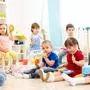Group of kindergarten children play with musical toys. Early musical education in day care centre