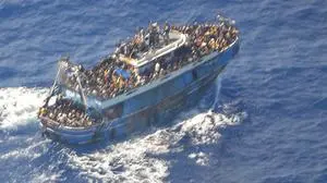 This undated handout image provided by Greece's coast guard on Wednesday, June14, 2023, shows scores of people on a battered fishing boat that later capsized and sank off southern Greece. A fishing boat carrying migrants trying to reach Europe capsized and sank off Greece on Wednesday, authorities said, leaving at least 79 dead and many more missing in one of the worst disasters of its kind this year.(Hellenic Coast Guard via AP)