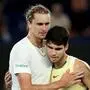 Germany's Alexander Zverev (L) embraces Spain's Carlos Alcaraz after their men's singles quarter-final match on day 11 of the Australian Open tennis tournament in Melbourne on January 25, 2024. (Photo by Martin KEEP / AFP) / -- IMAGE RESTRICTED TO EDITORIAL USE - STRICTLY NO COMMERCIAL USE --