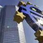 FILE -A Euro sculpture is seen in the autumnal sun in front of the European Central Bank ECB building, background, in Frankfurt, Germany, Sept. 24, 2007. (AP Photo/Bernd Kammerer, File)