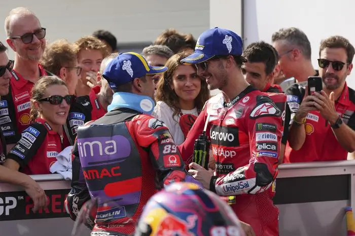 Italian rider Francesco Bagnaia of Ducati Lenovo Team, right, is congratulated by Spanish rider Jorge Martin of Prima Pramac Racing after winning the MotoGP race in Sepang, outskirts of Kuala Lumpur, Sunday, Nov. 3, 2024. (AP Photo/Vincent Thian)