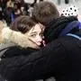 FILE - In this Nov.13, 2015 a supporter conforts a friend after invading the pitch of the Stade de France stadium at the end of the international friendly soccer match between France and Germany in Saint Denis, outside Paris. In an enormous custom-designed chamber, France is putting on trial 20 men accused in the Nov. 13, 2015, Islamic State terror attacks on Paris that left 130 people dead and hundreds injured. Nine gunmen and suicide bombers struck within minutes of each other at the national soccer stadium, the Bataclan concert hall and restaurants and cafes. Salah Abdeslam, the lone survivor of the terror cell from that night is among those being tried for the deadliest attack in France since World War II. (AP Photo/Christophe Ena, File)