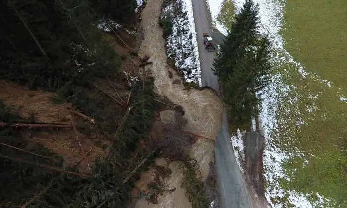 Luftbild mit Blick auf den weggerissenen Görzwinklweg und den hochwasserführenden Bach
