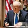 US President Donald Trump signs executive orders during a meeting with US Ambassadors in the Cabinet Room of the White House in Washington, DC, on March 25, 2025. (Photo by Mandel NGAN / AFP)