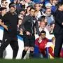 Fourth Official David Coote (C) stands betweeen Liverpool's German manager Jurgen Klopp (L) and Chelsea's Argentinian head coach Mauricio Pochettino during the English Premier League football match between Chelsea and Liverpool at Stamford Bridge in London on August 13, 2023. (Photo by HENRY NICHOLLS / AFP) / RESTRICTED TO EDITORIAL USE. No use with unauthorized audio, video, data, fixture lists, club/league logos or 'live' services. Online in-match use limited to 120 images. An additional 40 images may be used in extra time. No video emulation. Social media in-match use limited to 120 images. An additional 40 images may be used in extra time. No use in betting publications, games or single club/league/player publications. / 