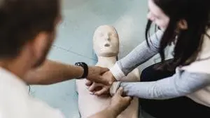 First aid resuscitation course in primary school. First aid cardiopulmonary resuscitation course in primary school. Kid practicing on resuscitation doll. Copyright: xZoonar.com/MatejxKastelicx 19348048 ,model released, Symbolfoto ,property released
