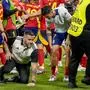 Spain's Alvaro Morata, centre, holds his leg after an incident with an invader after a semifinal match between Spain and France at the Euro 2024 soccer tournament in Munich, Germany, Tuesday, July 9, 2024. Left Spain's Rodri. (AP Photo/Hassan Ammar)