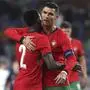 Portugal's Cristiano Ronaldo, right, and Nelson Semedo celebrates during a friendly soccer match between Portugal and Ireland at the Aveiro Municipal stadium in Aveiro, Portugal, Tuesday, June 11, 2024. (AP Photo/Luis Vieira)