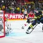 Sweden’s forward #23 Lucas Raymond tries to score on Austria's goalkeeper #30 David Kickert during the IIHF Men's Ice hockey World Championship match between Sweden and Austria in Stockholm, on May 10, 2025. (Photo by Jonathan NACKSTRAND / AFP)