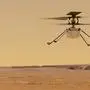 FILE - This illustration made available by NASA depicts the Ingenuity helicopter on Mars which was attached to the bottom of the Perseverance rover, background left. It will be the first aircraft to attempt controlled flight on another planet. (NASA/JPL-Caltech via AP)