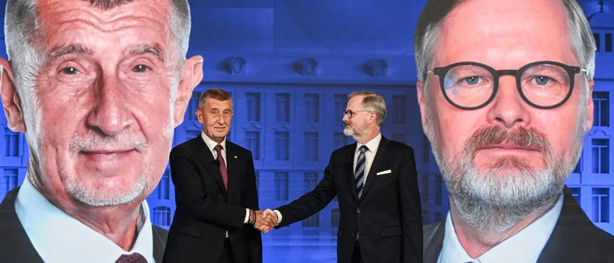 Leader of Czech Republic's ANO party Andrej Babis and Petr Fiala, Czech Prime Minster and Leader of Czech Republic's Civic Party (ODS) and Together (SPOLU) coalition, shake hands at the TV studio of CNN Prima tv prior to the election TV debate on October 1, 2025, in Prague, Czech Republic. Parliamentary elections are scheduled to be held in the Czech Republic on October 3, 2025. (Photo by Michal Cizek / AFP)