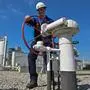 A worker operates equipment operated by GCA (Gas Connect Austria) and TAG (Trans Austria Gas pipelines) at one of the largest interconnection gas hubs in Europe at Baumgarten an der March, Lower Austria. - The facility mainly receives Russian imports, but takes also shipments of gas from Norway and some other countries. These supplies are re-routed to consumption centers in Austria and in Europe via a number of pipeline systems running in various directions. The Baumgarten hub consists of gas reception, metering and testing facilities. (Photo by JOE KLAMAR / AFP)