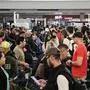 Travelers wait in line at a security checkpoint at George Bush Intercontinental Airport in Houston, Texas on November 7, 2025. Hundreds of flights were canceled across the United States on Friday after the Trump administration ordered reductions to ease strain on air traffic controllers who are working without pay amid congressional paralysis on funding the US budget. Forty airports were due to slow down, including the giant hubs in Atlanta, Newark, Denver, Chicago, Houston and Los Angeles. (Photo by RONALDO SCHEMIDT / AFP)