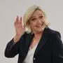 CORRECTION / TOPSHOT - Head of French far-right Rassemblement National (RN) parliamentary group at the National Assembly Marine Le Pen waves before heading into a booth to mark her ballot at in the first round of parliamentary elections  in Henin-Beaumont, North of France, on June 30, 2024. A divided France is voting in high-stakes parliamentary elections that could see the anti-immigrant and eurosceptic party of Marine Le Pen sweep to power in a historic first. The candidates formally ended their frantic campaigns at midnight June 28, with political activity banned until the first round of voting. (Photo by FRANCOIS LO PRESTI / AFP) / “The erroneous mention[s] appearing in the metadata of this photo by Francois LO PRESTI has been modified in AFP systems in the following manner: [Marine Le Pen] instead of [Marie-Caroline Le Pen]. Please immediately remove the erroneous mention[s] from all your online services and delete it (them) from your servers. If you have been authorized by AFP to distribute it (them) to third parties, please ensure that the same actions are carried out by them. Failure to promptly comply with these instructions will entail liability on your part for any continued or post notification usage. Therefore we thank you very much for all your attention and prompt action. We are sorry for the inconvenience this notification may cause and remain at your disposal for any further information you may require.”