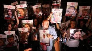 Demonstrators carry posters during a demonstration calling for the release of Israeli hostages held by Palestinian militants since the October 7 attack, in Tel Aviv on October 21, 2023. UN chief Antonio Guterres pleaded October 21, for a "humanitarian ceasefire" in the war between Israel and Hamas militants that has devastated much of Gaza, demanding "action to end this godawful nightmare". (Photo by AHMAD GHARABLI / AFP)