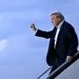 US President Donald Trump raises a fist as he steps off Air Force One at Palm Beach International Airport in West Palm Beach, Florida, on April 11, 2025. Trump is heading to Palm Beach to spend the weekend at his Mar-a-Lago resort. (Photo by Mandel NGAN / AFP)